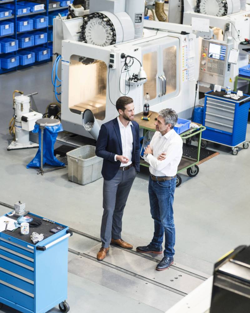 Businessmen during meeting in production hall Businessmen during meeting in production hall